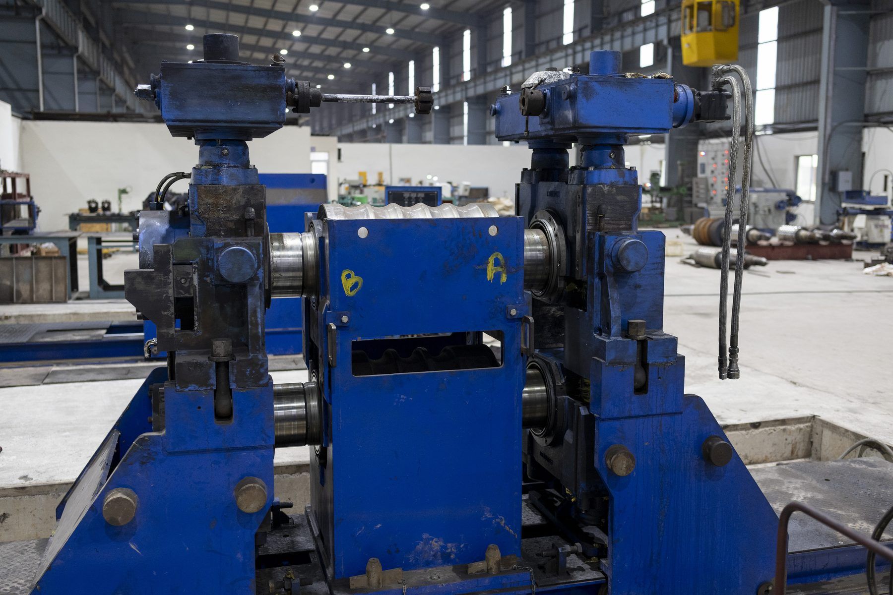 Blue rolling stand with maintenance markings in the mill