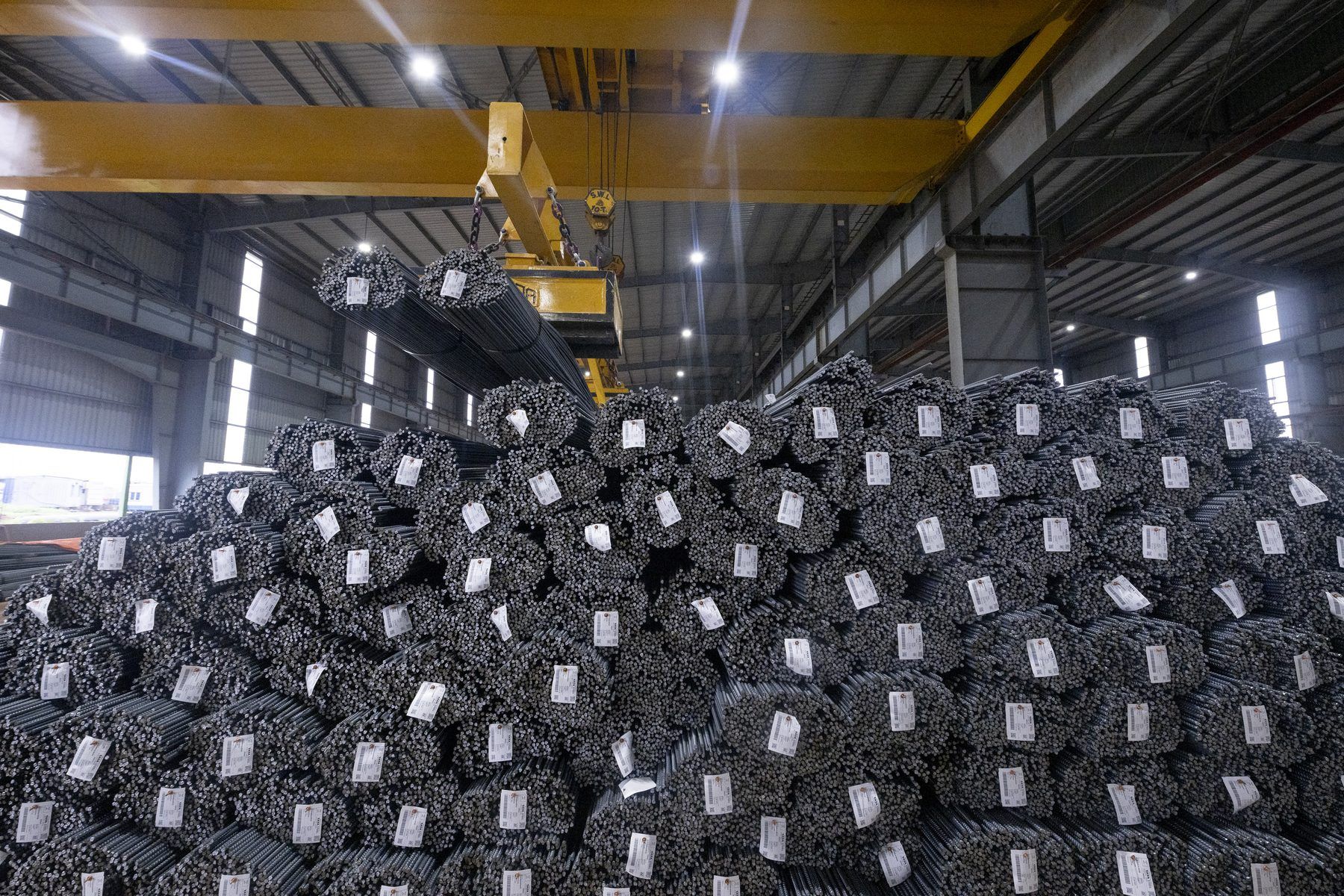Tagged bundles of TMT bars stacked in the dispatch bay
